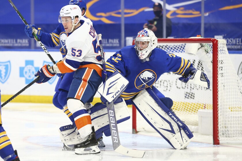 Buffalo Sabres goalie Michael Houser (32) is bumped into by New York Islanders forward Casey Cizikas (53) during the second period of an NHL hockey game, Monday, May 3, 2021, in Buffalo, N.Y. (AP Photo/Jeffrey T. Barnes)