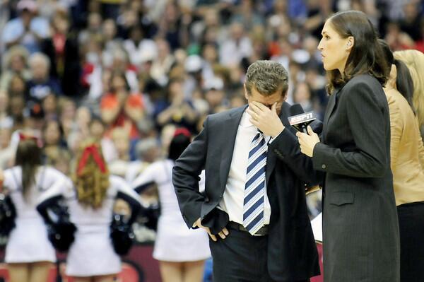 UConn Head Coach Geno Auriemma shows his discontent as UConn trails Stanford 20-12 at the half while being pulled aside by ESPN commentator and former UConn player Rebecca Lobo at the Final Four at the Alamodome in San Antonio, Texas Tuesday April 6, 2010 for the national women's basketball championship.
