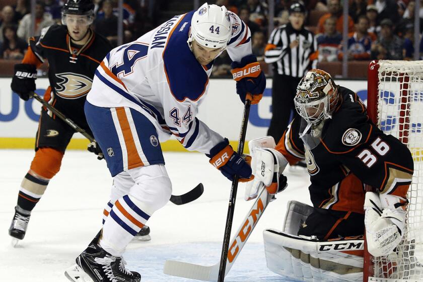 Edmonton Oilers right wing Zack Kassian (44) controls the puck in front of Ducks goalie John Gibson (36) and defenseman Cam Fowler (4) during the first period Tuesday.