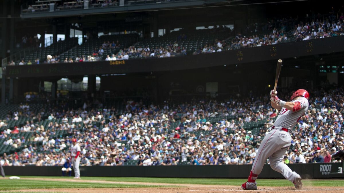 Angels slugger Mike Trout hits a two-run single against the Seattle Mariners on June 2.