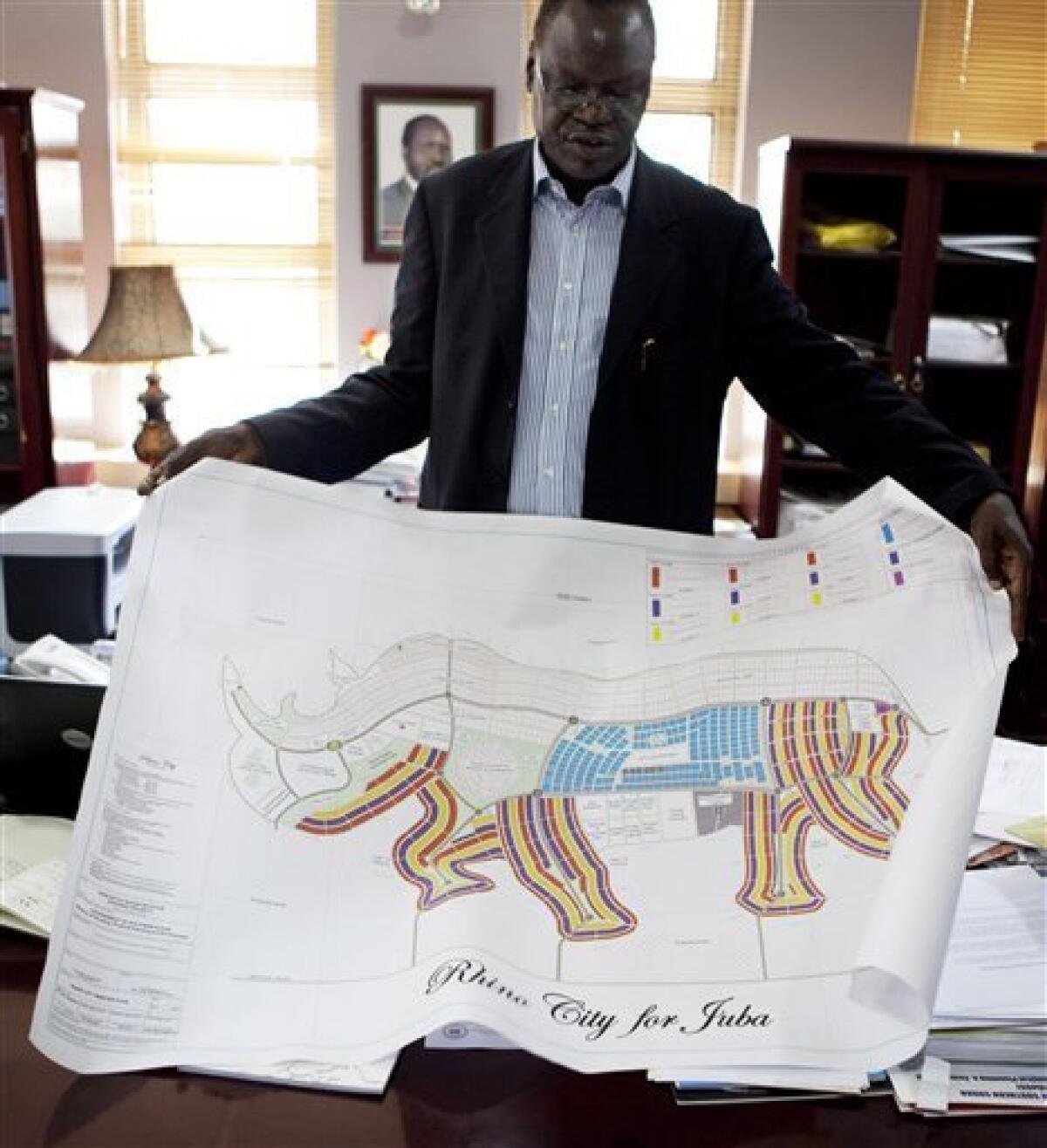 Dr. Daniel Wani, Undersecretary for the Ministry of Housing and Physical Planning in the Government of South Sudan, explains a map of Juba in the shape of an rhino, Wednesday, Aug 18, 2010, in Juba, Southern Sudan. A city shaped like a giraffe? A rhino-shaped town? Even one like a pineapple?Southern Sudan has unveiled ambitious plans to remake its capital cities in the shapes found on their state flags, and an official says the government is talking with investors to raise the $10 billion the fanciful communities would cost.(AP Photo/Pete Muller)