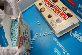 A box of Whoppers with round blue pill instead of candy. Sheriffs department confiscated fentanyl pills packaged in candy wrappers as a suspect attempted to go through TSA screening.
