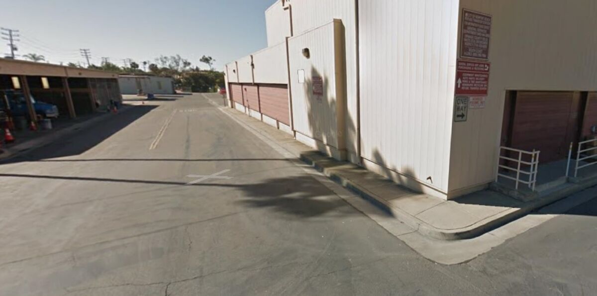 A warehouse, foreground, and a partially enclosed equipment garage, left, could be converted into a homeless shelter at Newport Beach's public works yard on Superior Avenue.