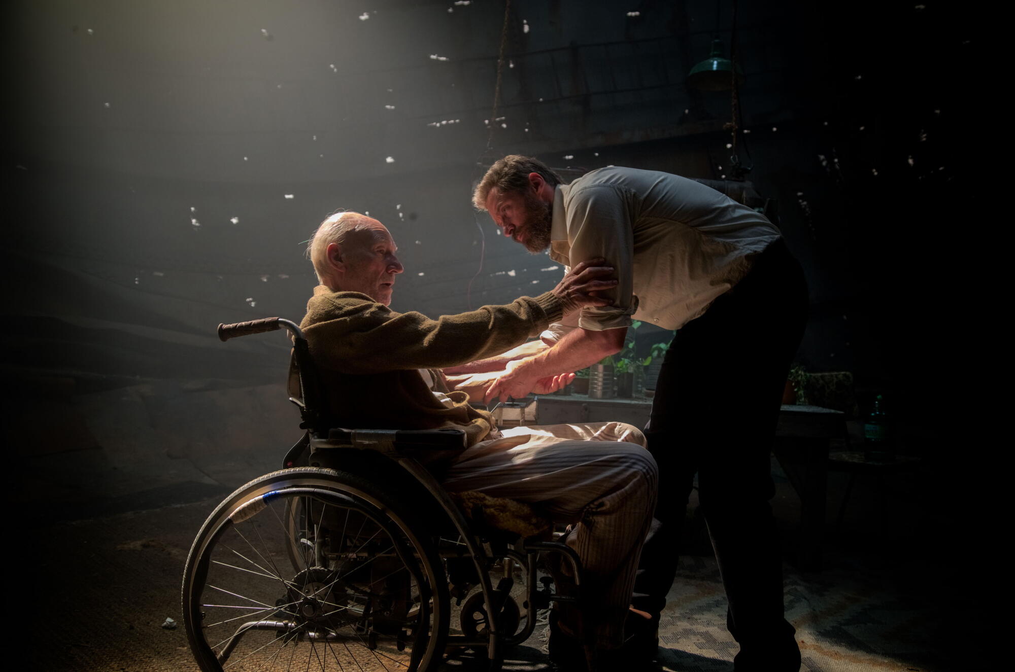 Patrick Stewart, sitting in a wheelchair, and Hugh Jackman in 
