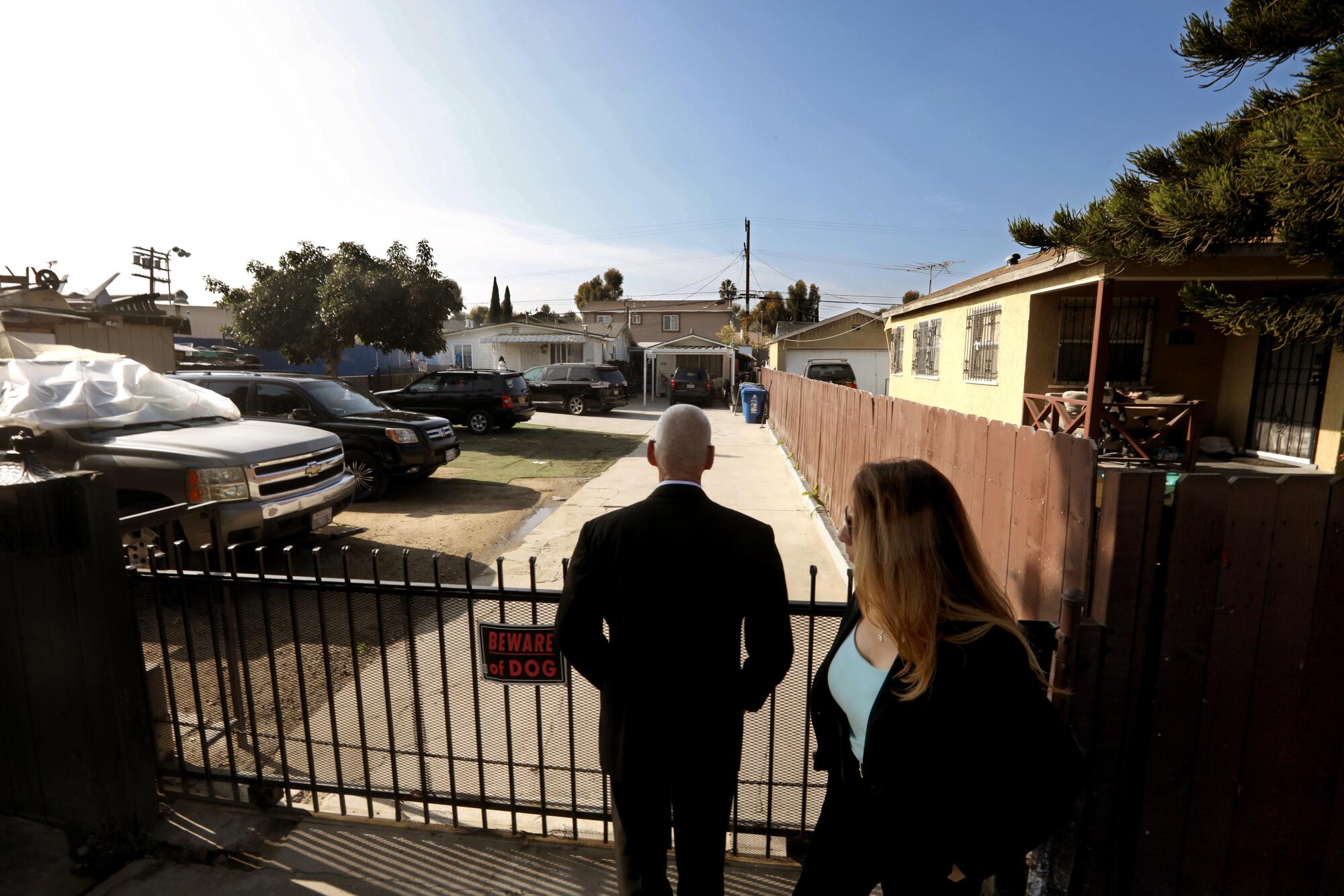  Retired LAPD detectives David Ross, left, and Bertha "B" Durazo stand outside Ruby Scott's former home in Watts.