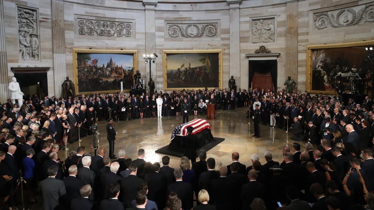 The flag-draped casket of Sen. John McCain arrives inside the Rotunda of the U.S. Capitol on Friday in Washington, DC.