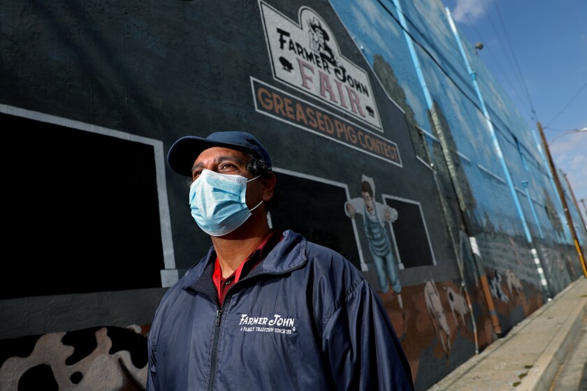 Pedro Albarran wearing a mask outside a meat processing plant