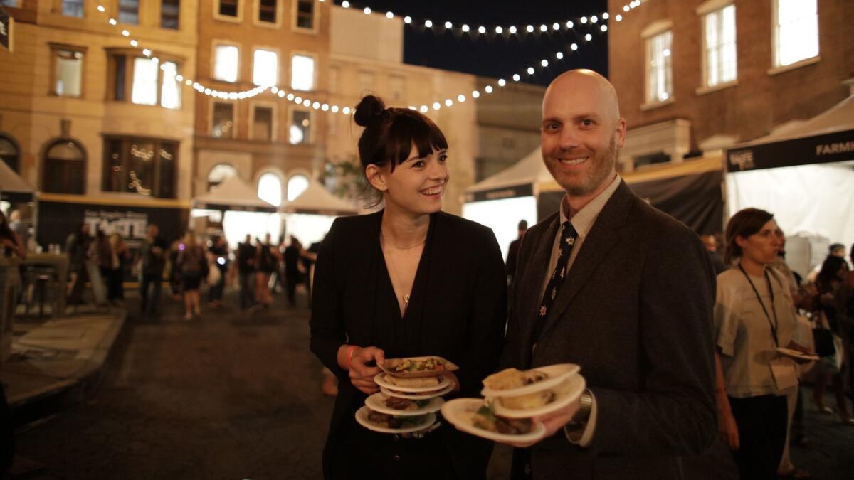 Festival-goers collect plates during The Taste's opening night.