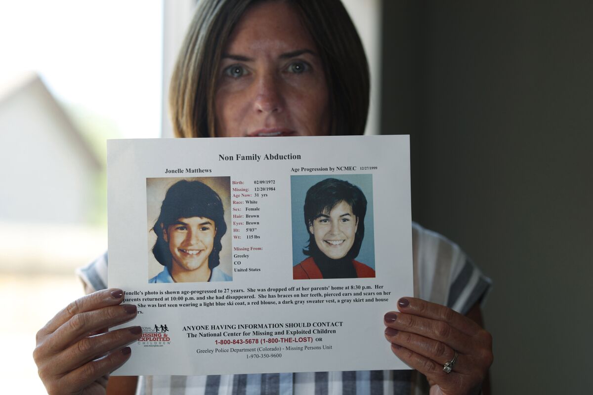 FILE - In this Aug. 12, 2019, file photo, Jennifer Mogensen holds a poster of her adopted sister, Jonelle Matthews, who went missing and whose remains were found recently in Greeley, Colo. The trial for Steve Pankey, a former longshot candidate for Idaho governor who has been indicted in the murder of Jonelle Matthews, is set to begin Wednesday, Oct. 13, 2021. (AP Photo/David Zalubowski, File)