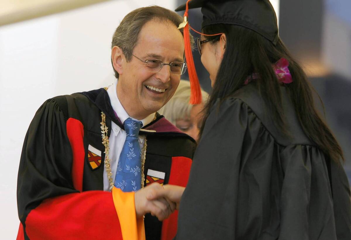 Dr. Jean–Lou Chameau congratulates a graduate in 2007. He led Caltech for seven years, raising $900 million in donations and bringing the school's endowment to $1.9 billion.