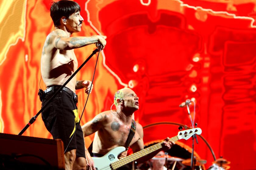 Red Hot Chili Peppers continue their Global Stadium Tour at SoFi Stadium in Inglewood on Sunday, July 31, 2022. Above, lead singer Anthony Kiedis, left and bassist Flea.
