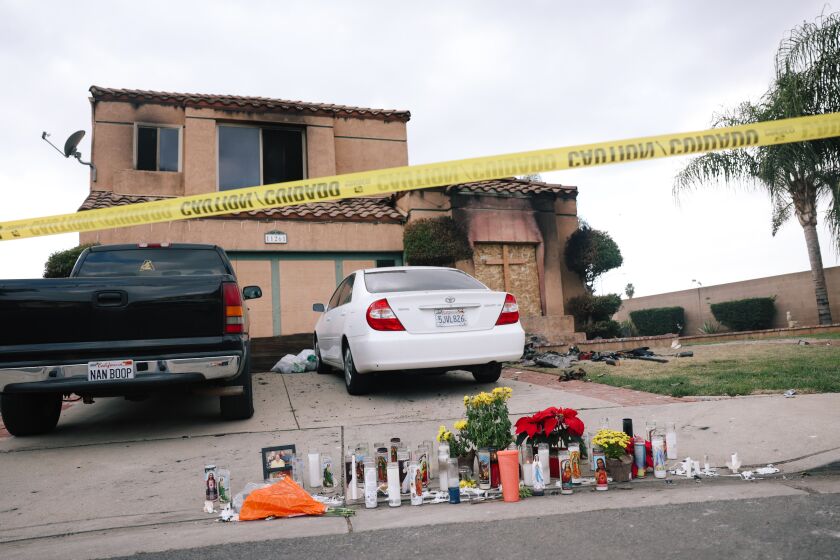 Riverside, CA - November 28: A memorial is seen outside a home where the deaths of three people were found Friday in a burning home at a residence on Monday, Nov. 28, 2022 in Riverside, CA. They are thought to be connected to the attempted abduction of a teenage girl. (Dania Maxwell / Los Angeles Times)