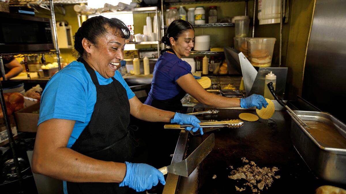 Silvia Martinez, left, and Veronica Juarez prepare orders at Teddy's Tacos in City of Industry.