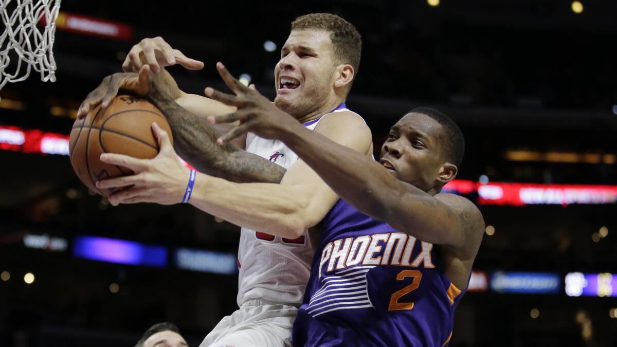 Clippers forward Blake Griffin, left, is fouled by Phoenix Suns guard Eric Bledsoe during the first half of the Clippers' 121-120 victory at Staples Center on Dec. 8.