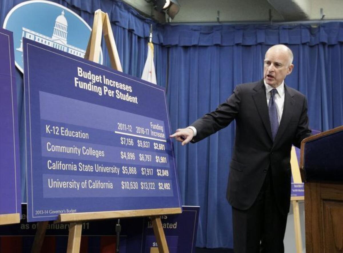 Gov. Jerry Brown points to a chart as he details his proposed budget in January.