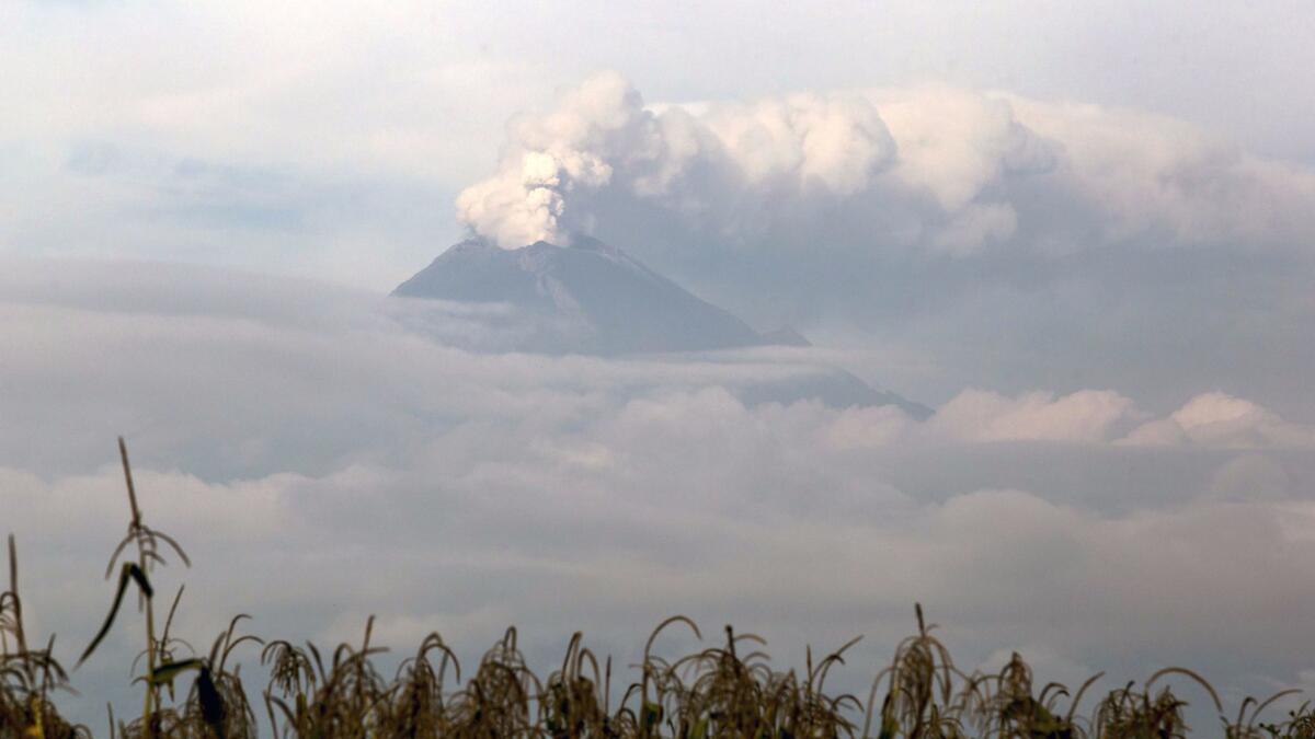A column of steam and gas rises from the Popocatepetl volcano on Sept. 27, eight days after a powerful earthquake rocked central Mexico.