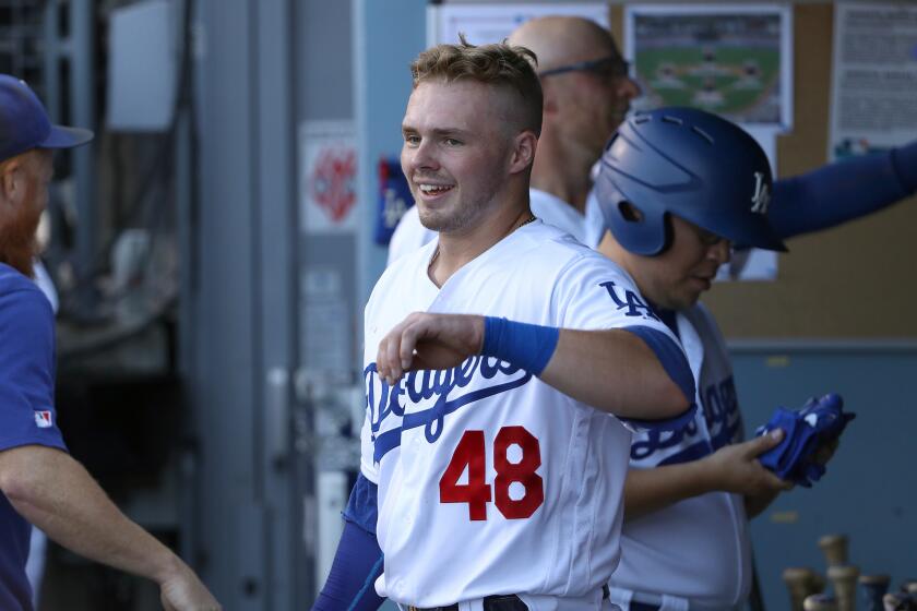 LOS ANGELES, CALIFORNIA - SEPTEMBER 02: Gavin Lux #48 of the Los Angeles Dodgers smiles in the dugout after scoring in the second inning of the MLB game against the Colorado Rockies at Dodger Stadium on September 02, 2019 in Los Angeles, California. (Photo by Victor Decolongon/Getty Images)