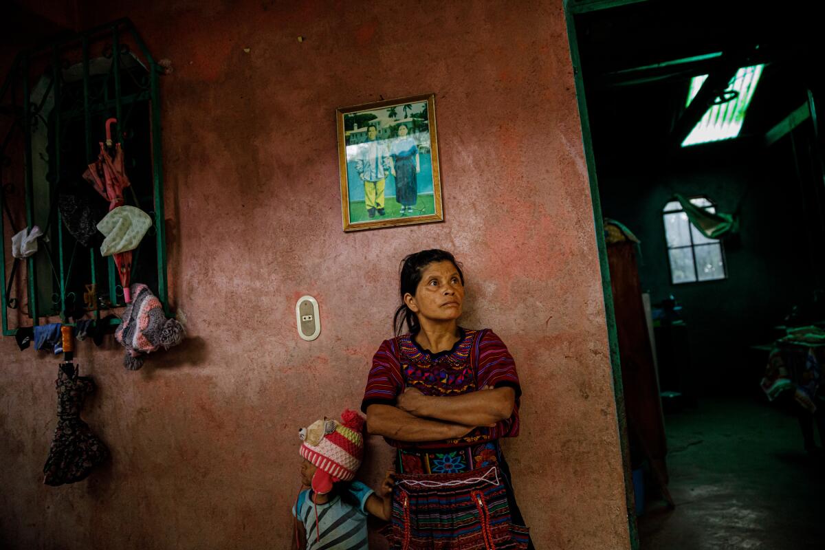 Claudia Perez, 45, and her daughter Keili Chales, 4, stands outside their home in Todos Santos Cuchumatn, Guatemala.