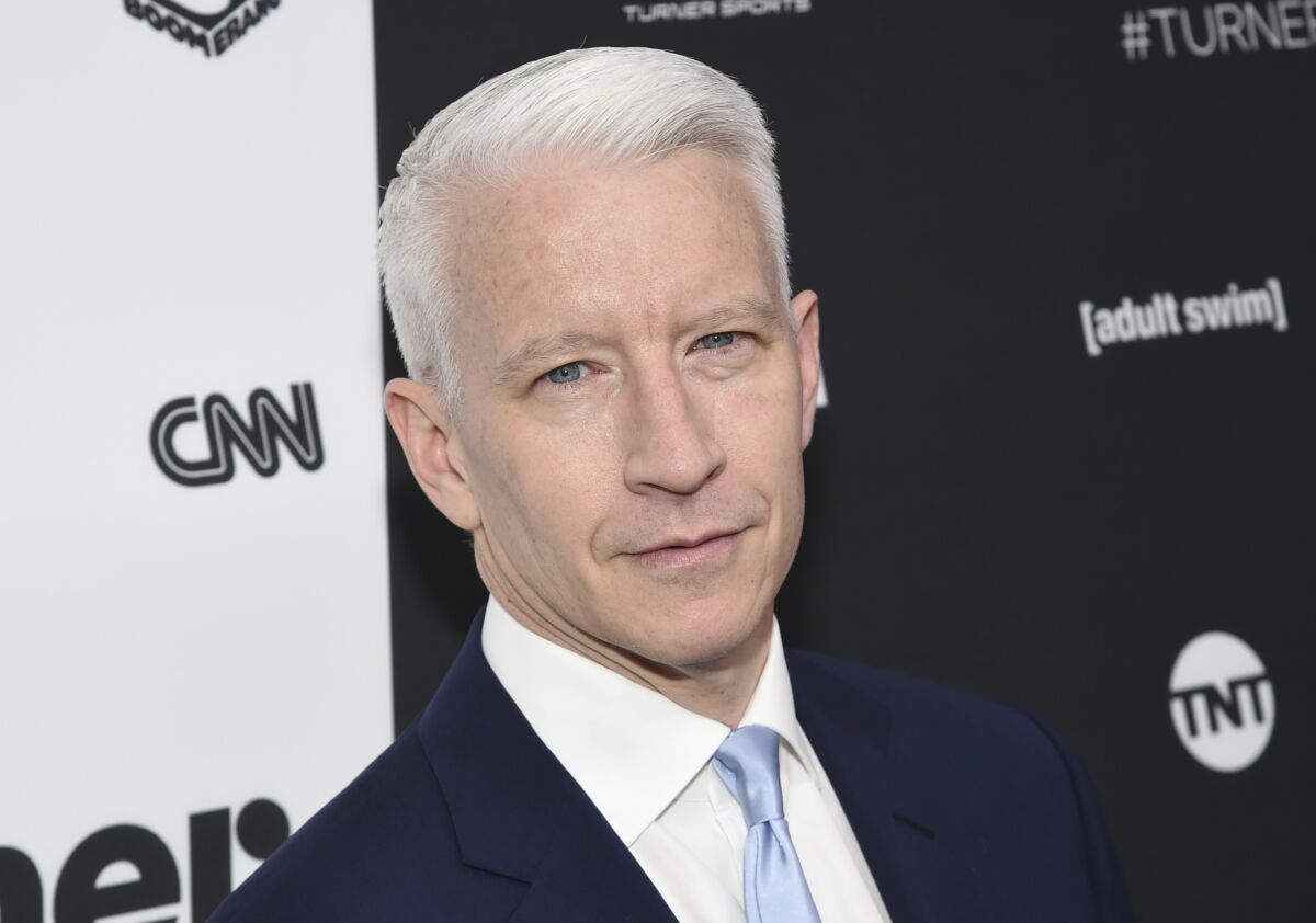 A man in a navy suit with short silver hair 