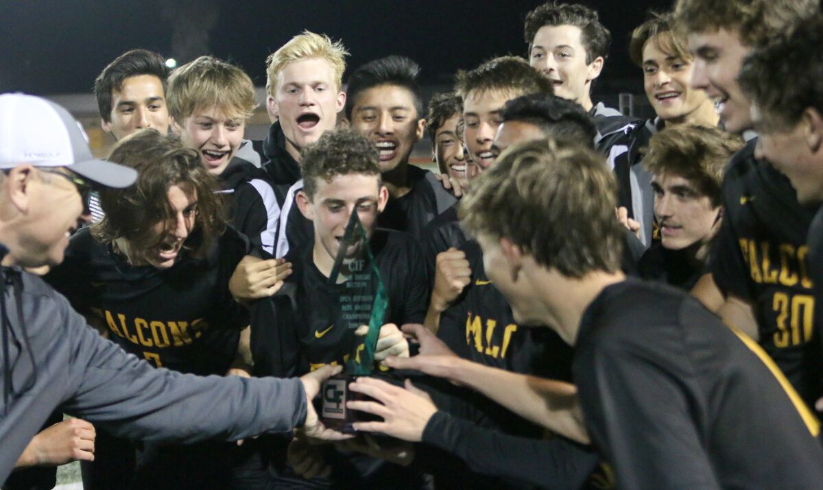 Coach Andy Hargreaves shares the CIF trophy.