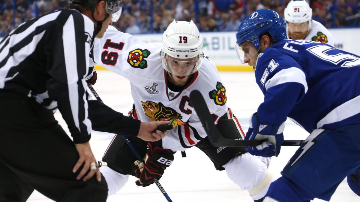 Chicago Blackhawks captain Jonathan Toews, center, faces off against Tampa Bay Lightning center Valtteri Filppula during the Blackhawks' win in Game 1 of the Stanley Cup Final on June 3.