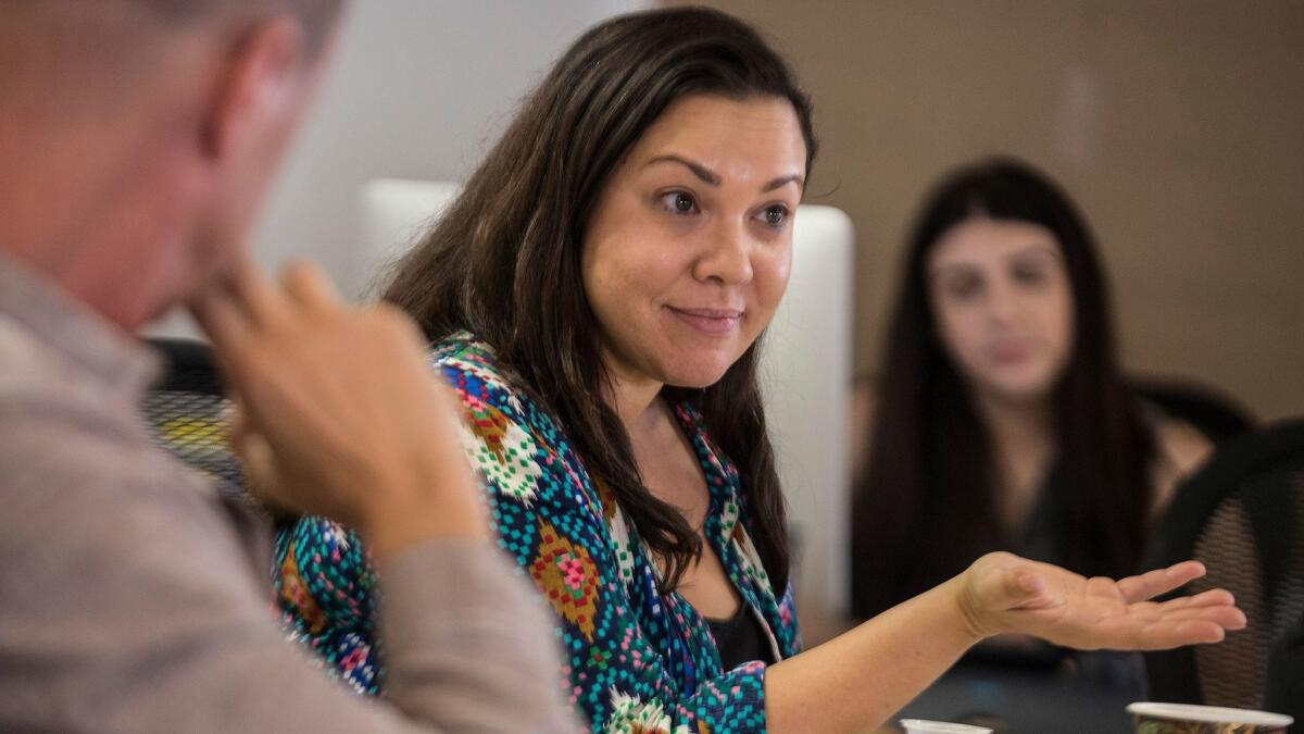 "One Day at a Time" writers and co-creators Gloria Calderon Kellet, right, and Mike Royce, left, during a meeting in the show's writing room.