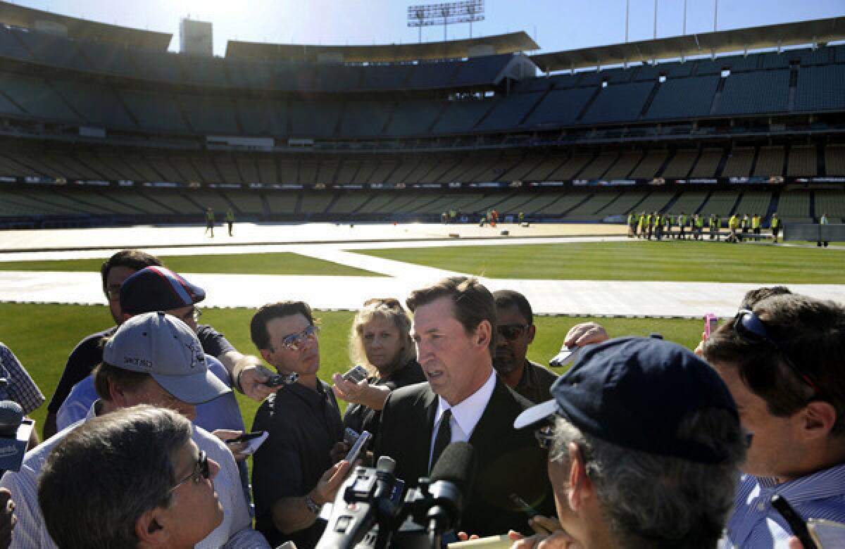 Former NHL great Wayne Gretzky speaks with reporters Monday at Dodger Stadium.