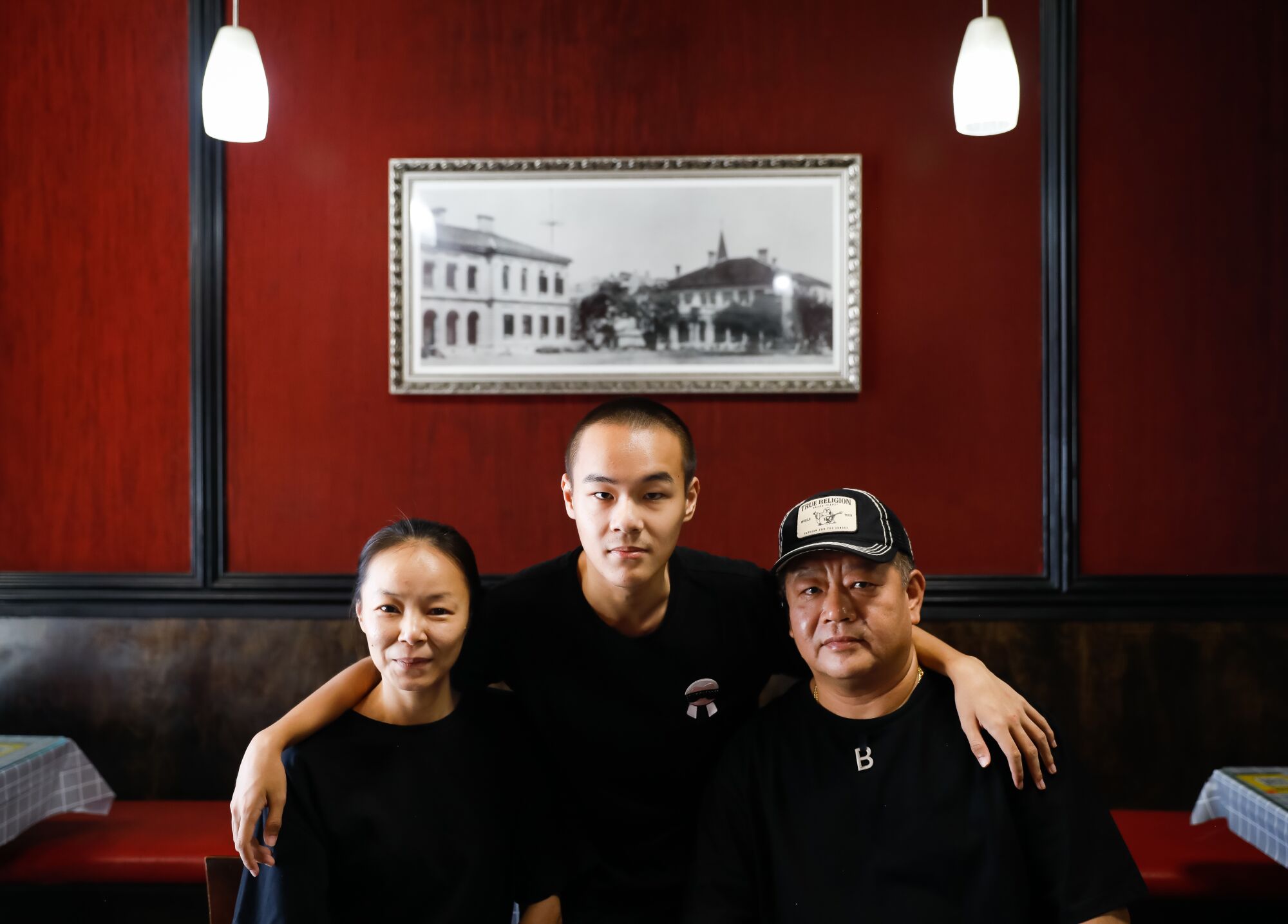 Lulu Luo, left, and Jack Ma, right, with their son Kevin Ma, center, at WangJia restaurant.