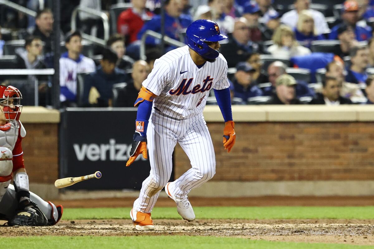 New York Mets' Dominic Smith (2) drops his bat after hitting an RBI-single to drive in Jeff McNeil and Pete Alonso against the Philadelphia Phillies during the fifth inning of a baseball game, Sunday, May 1, 2022, in New York. (AP Photo/Jessie Alcheh)