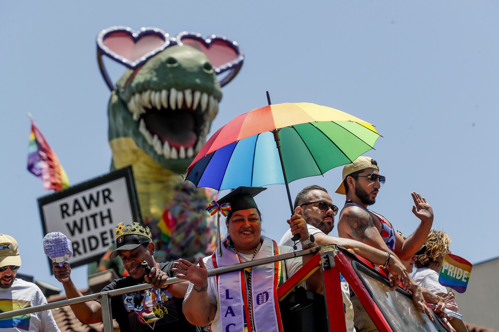 Paradegoers cheering atop a tour bus