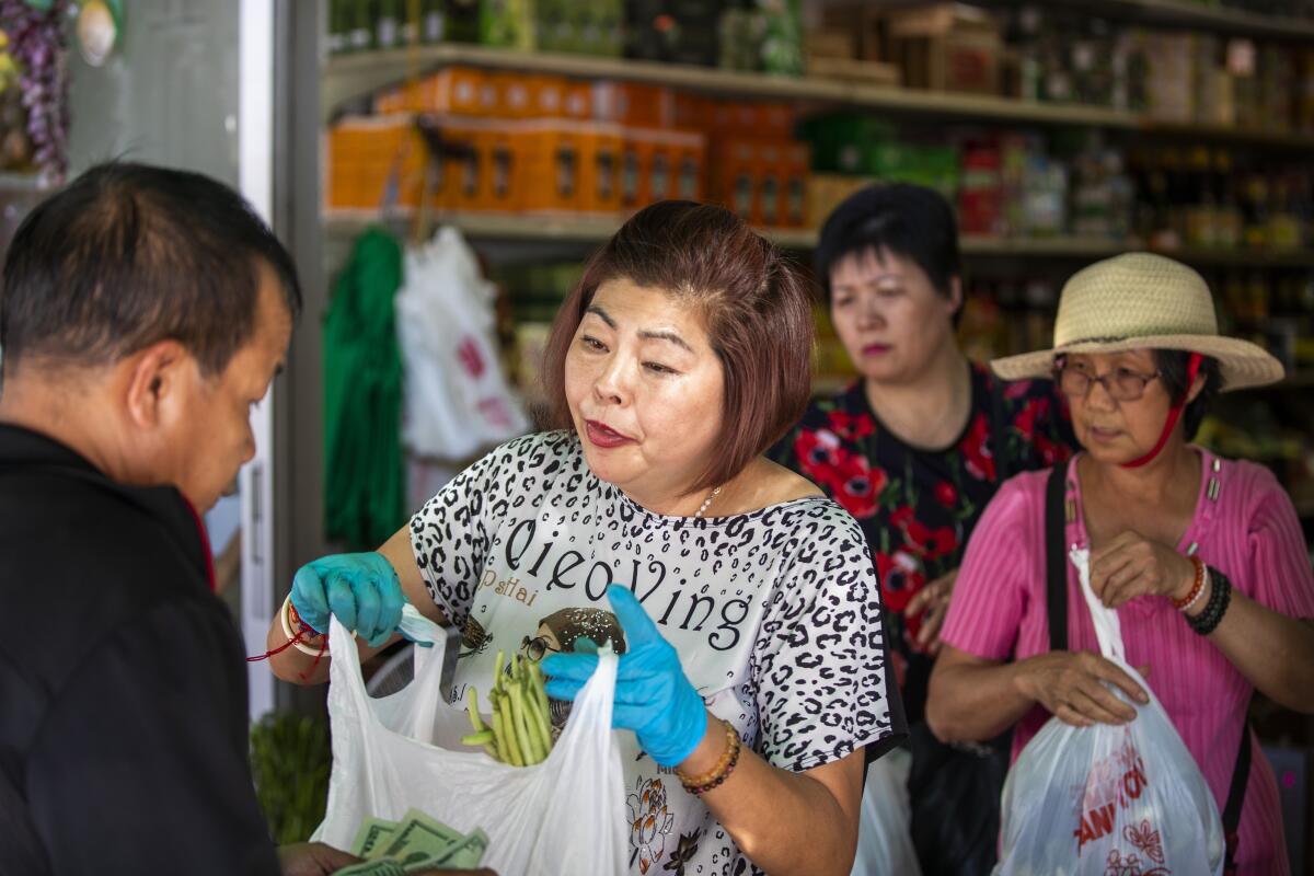 Yue Wa Market owner Amy Tran helps customers