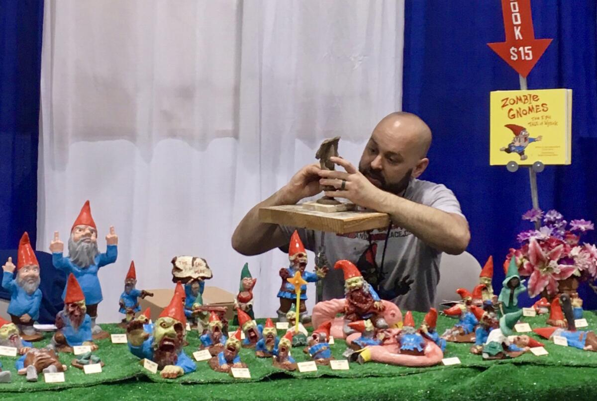 Chris Stever, of Chris & Jane’s Place: Zombie Gnomes, sculpts a zombie gnome during WonderCon.