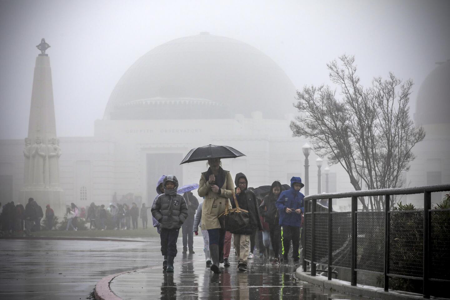 People visit Griffith Observatory in the rain on Wednesday.