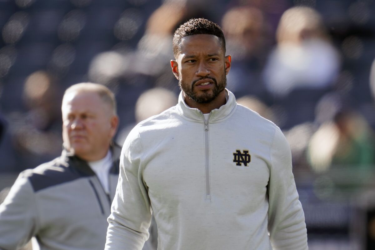 FILE - Notre Dame defensive coordinator Marcus Freeman watches during warmups before an NCAA college football game against Navy in South Bend, Ind., Saturday, Nov. 6, 2021. Notre Dame is working on a deal to promote defensive coordinator Marcus Freeman to head coach to replace Brian Kelly, a person with knowledge of the situation told The Associated Press on Wednesday night, Dec. 1, 2021. (AP Photo/Paul Sancya, File)