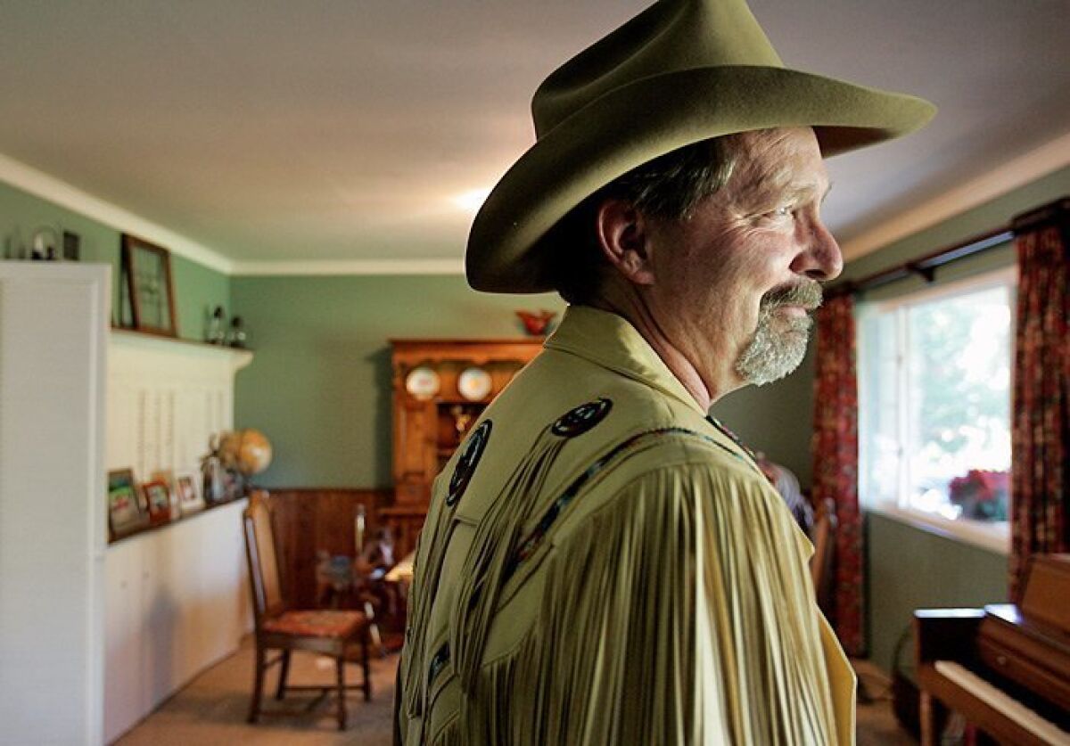 Clothes make the man: Buck Howdy models his beloved Western fringe jacket at his home in Poway. — John Gastaldo / Union-Tribune