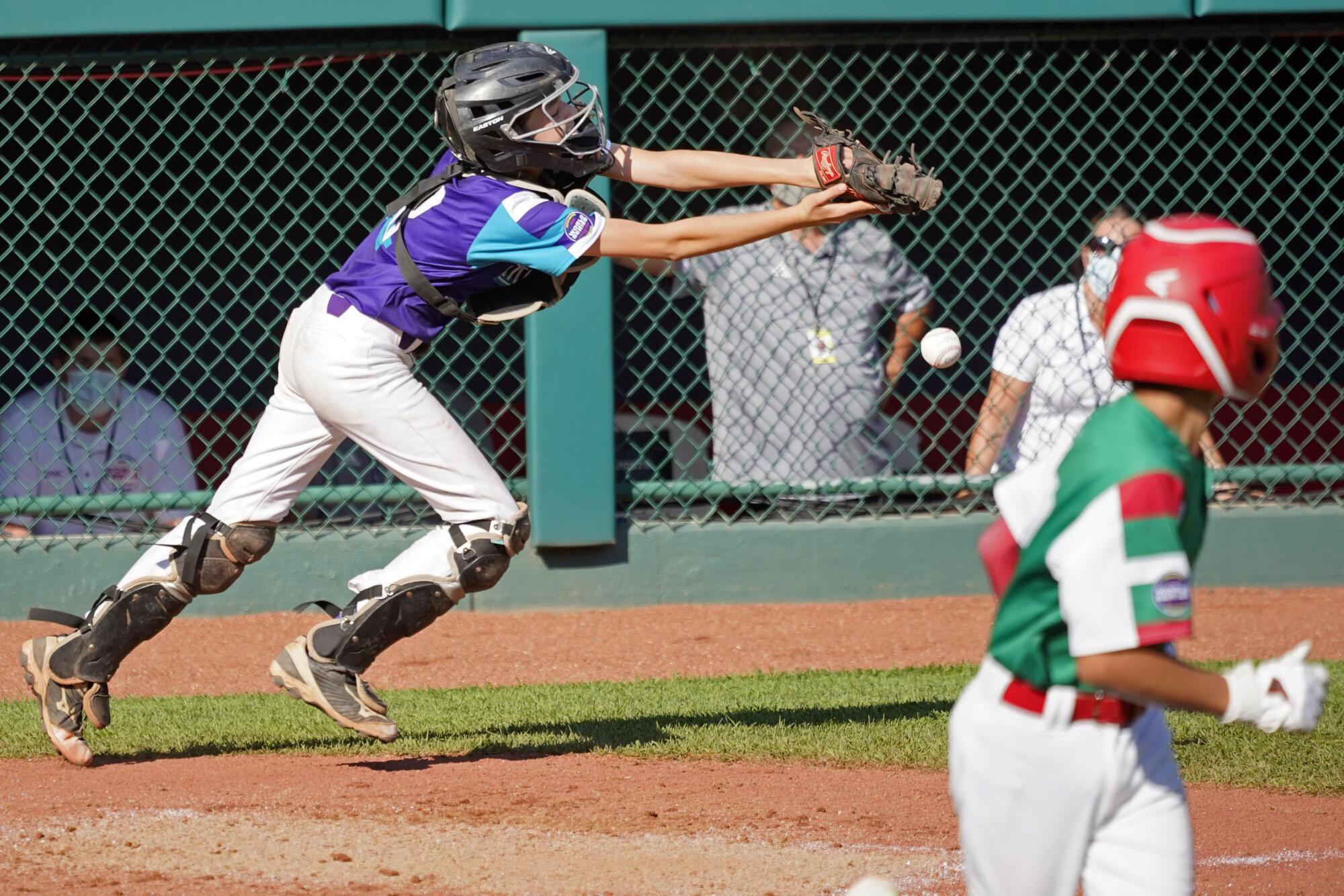 Abilene, Texas catcher Ella Bruning (8) drops a foul pop up by Abilene, Texas' Colton Skiles (9)