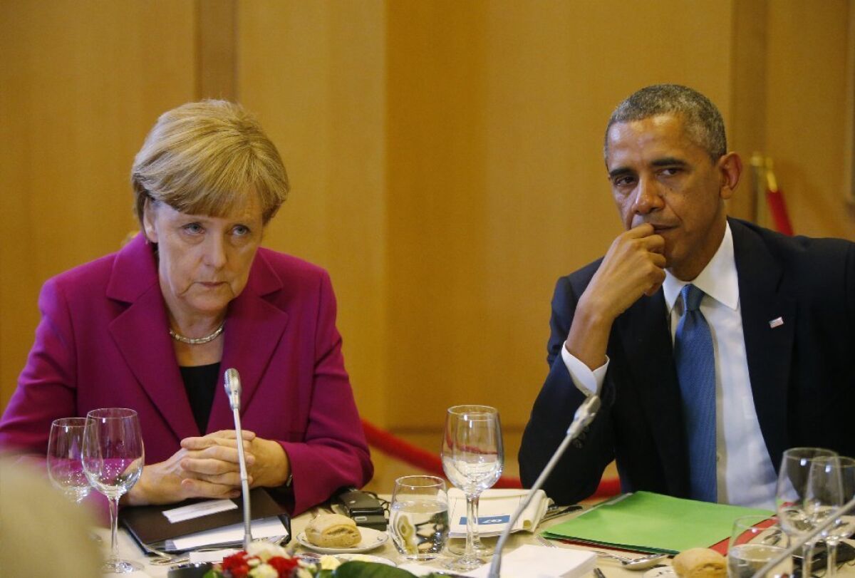 President Obama is seen with German Chancellor Angela Merkel at a G-7 working dinner in Brussels on June 4.