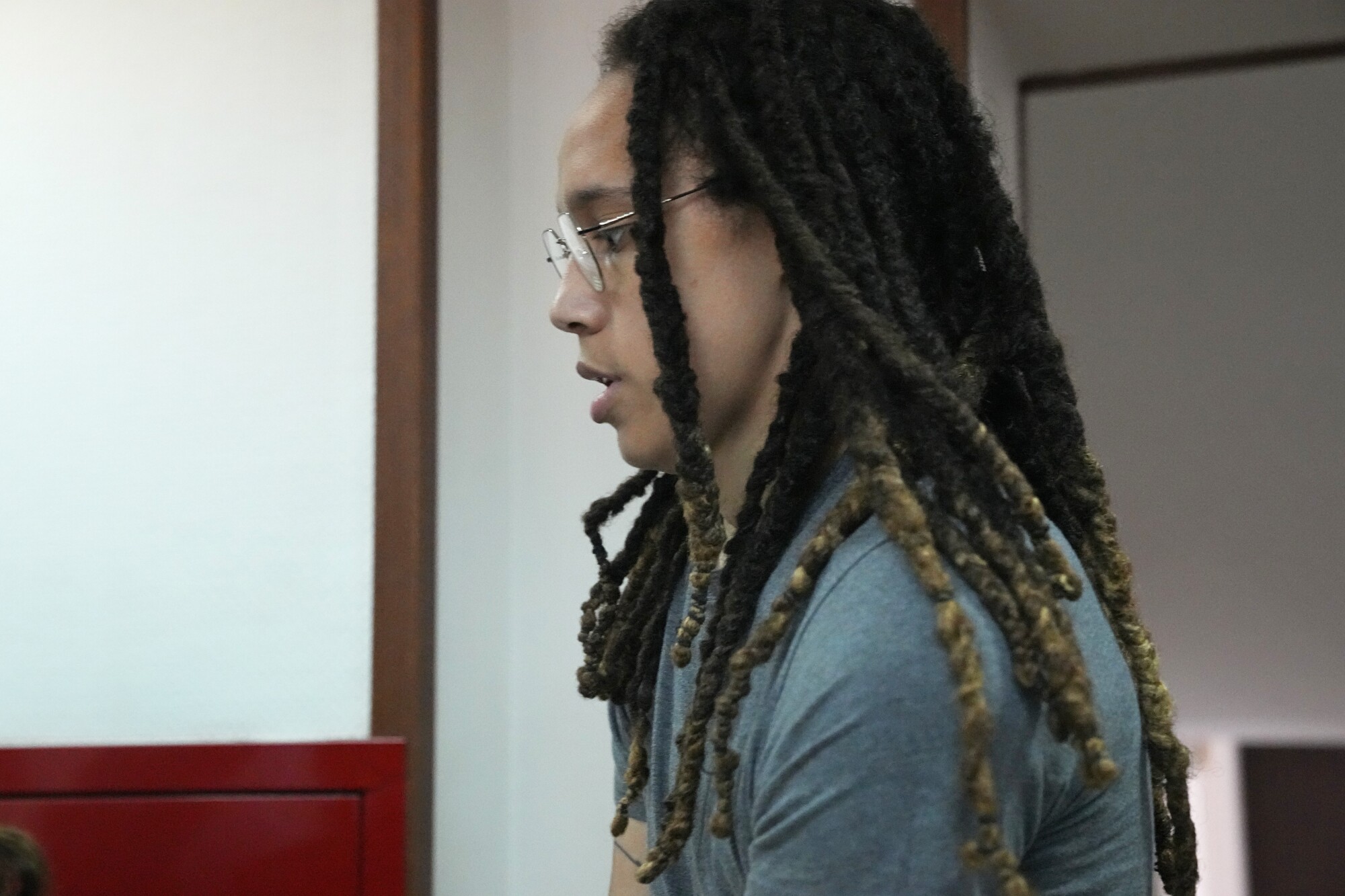 Brittney Griner is escorted to a courtroom for a hearing.