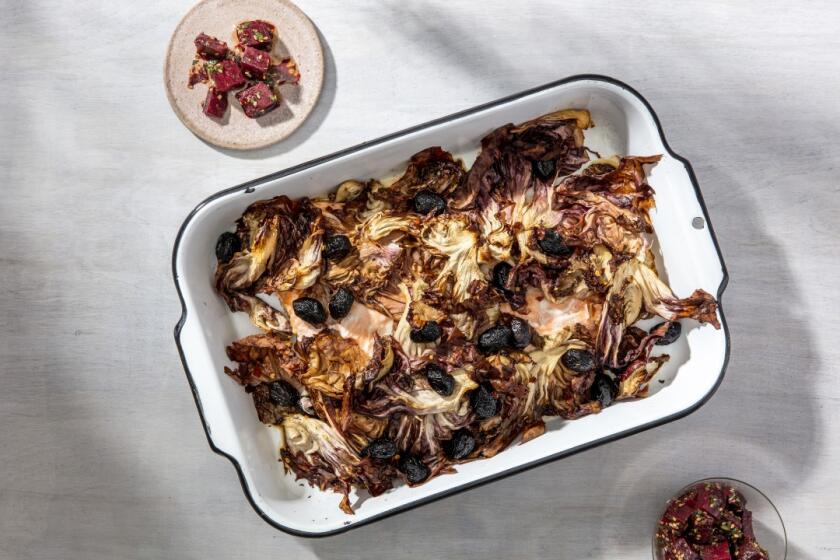 Whole radicchio leaves, spiced with chile flakes, wilt down to crispy chips atop a roasted side of salmon with salt-cured olives, all shot here with the side of Sesame-Sizzled Beets. Prop styling by Rebecca Buenik.