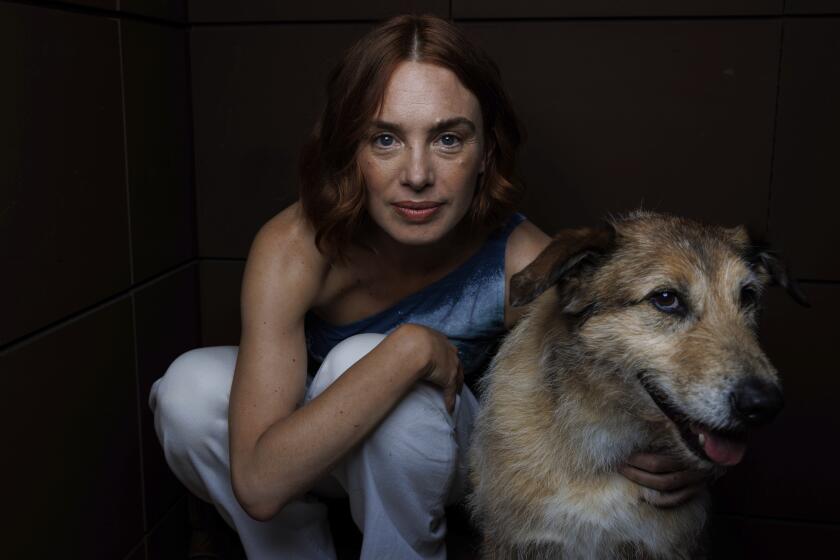 Director Laetitia Dosch and Cosmos pose for portrait photographs for the film 'Dog on Trial' at the 77th international film festival, Cannes, southern France, Saturday, May 18, 2024. (Photo by Vianney Le Caer/Invision/AP)