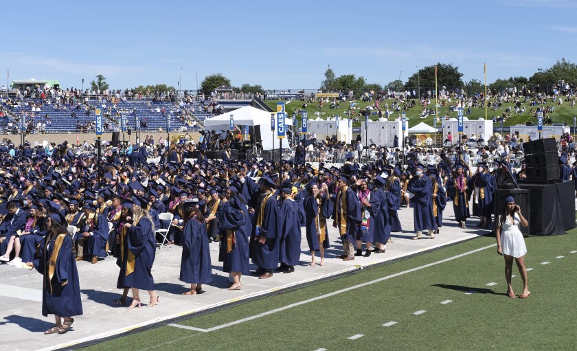 UC Davis graduates line up at UC Davis Health Stadium to pick up their diplomas Friday, June 10.