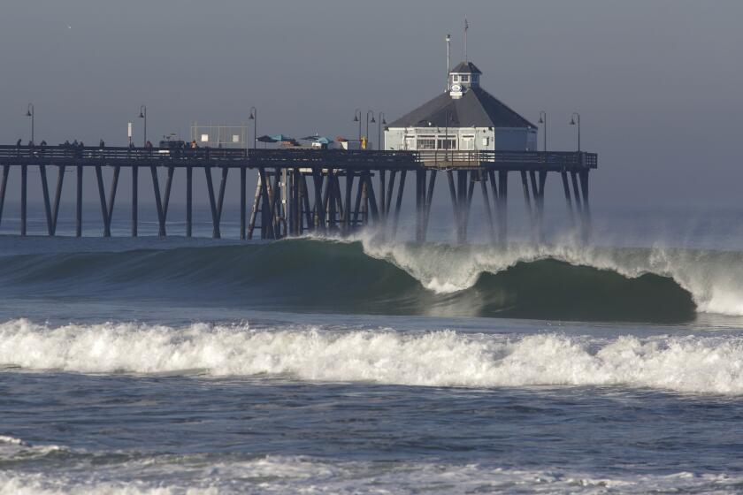 Imperial Beach, CA - March 17: A slight on-shore breeze blows back the crests of some sizable waves south of the Imperial Beach Pier on Thursday, March 17, 2022 in Imperial Beach, CA. (Bill Wechter /For The San Diego Union-Tribune)