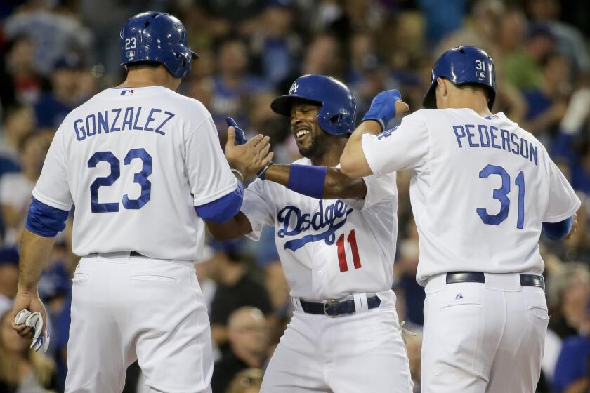 Dodgers shortstop Jimmy Rollins (11) celebrates his three-run home run against his former team, the Phillies, with Adrian Gonzalez and Joc Pederson.