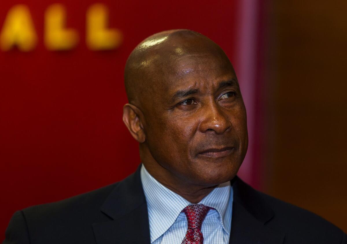 USC athletic director Lynn Swann pauses during a news conference at USC.
