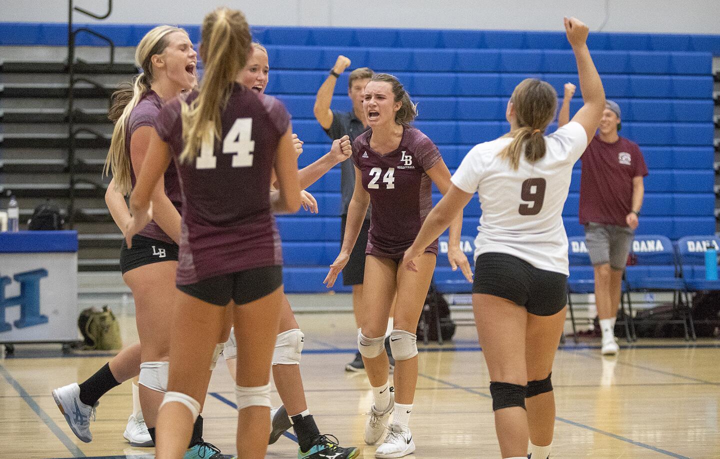 Laguna Beach celebrates winning a point over Dana Hills during a nonleague match on Thursdasy, August 16.