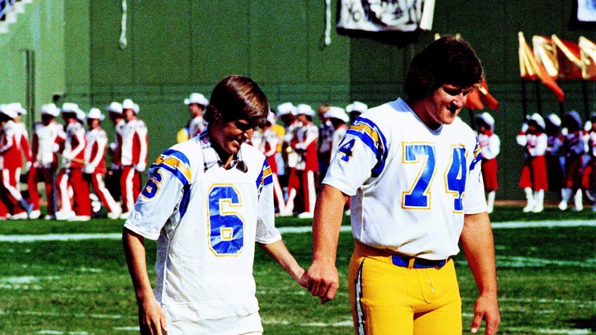 Chargers kicker Rolf Benirschke, who had been hospitalized, joins Louie Kelcher (74) to participate in the coin toss before the Chargers-Steelers game on Nov. 19, 1979.