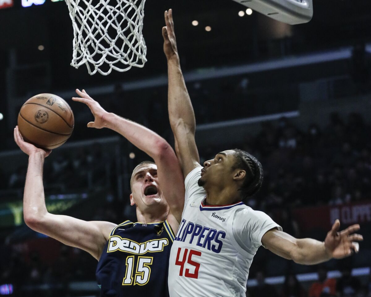 Denver Nuggets center Nikola Jokic is challenged by Clippers guard Keon Johnson in the first half.