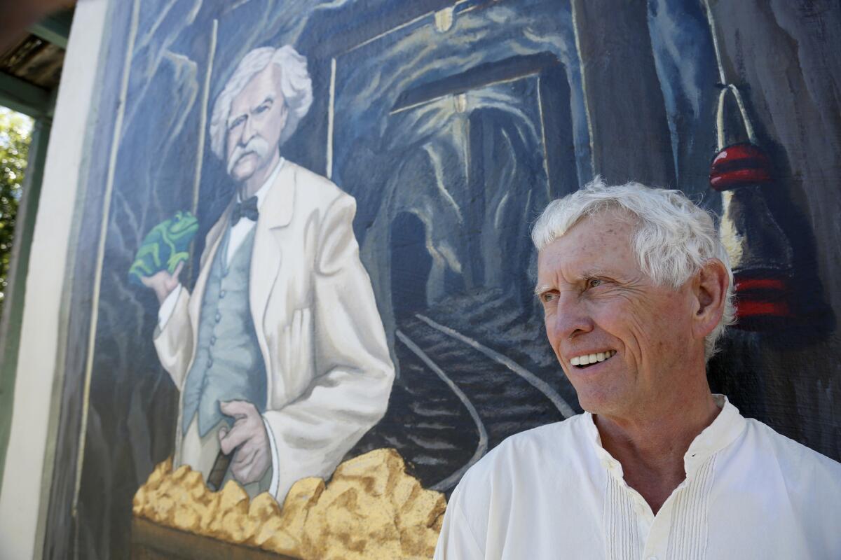 Author James Fletcher stands next to a mural of Mark Twain in Angels Camp. Fletcher wrote the book "Mark Twain's 88 Days In the Mother Lode."