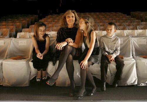 Diane Von Furstenberg sits with her grandchildren