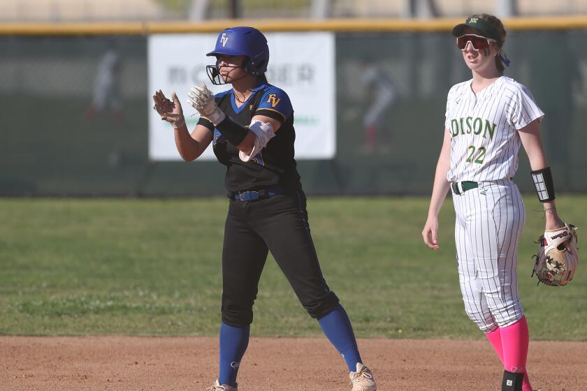 Fountain Valley's Ella Kim claps as she stands on second base with a two-run double against Edison.